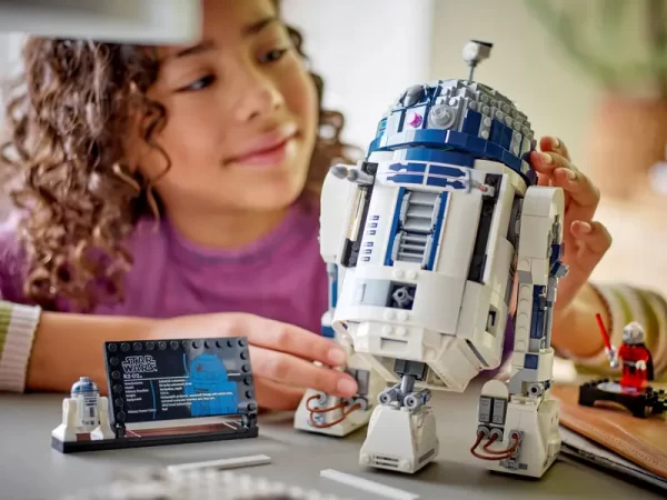 Child looking at Lego Star Wars R2-D2 set