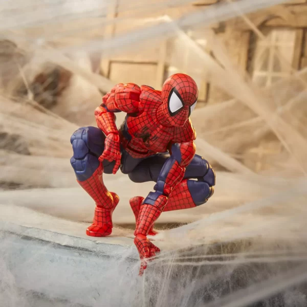 Hasbro Marvel Legends Maximum Series Spider-Man crouching on roof top with webs in the background.
