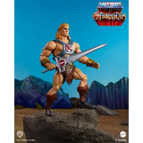 Mattel Masters of the Universe Origins x Thundercats He-Man. Posed with his sword at side with Eternia in the background.